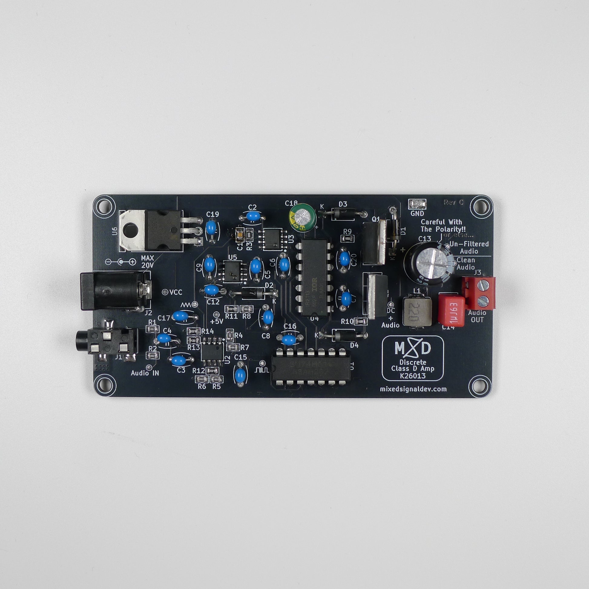 An electronic signal generator circuit board by Mixed Signal Development, featuring various electronic components, a black power jack, and a silver rotary volume control, photographed from directly above on a light gray background.